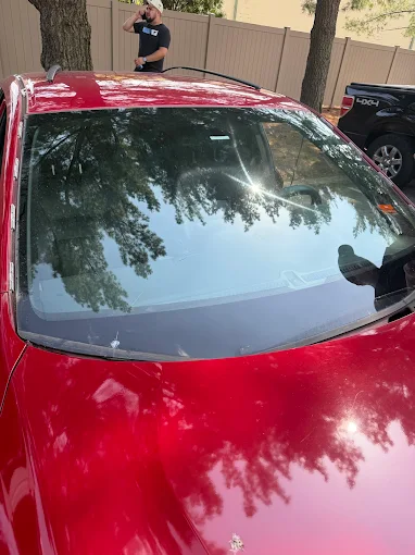 Finished windshield replacement on a red sedan by MCA
