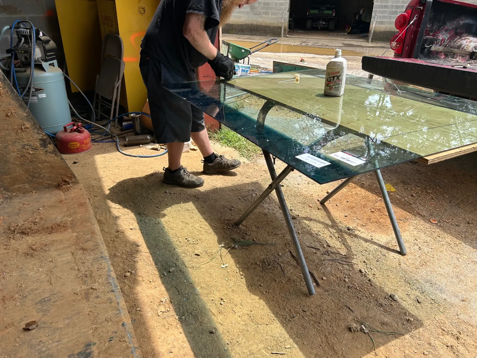MCA technician handling a large sheet of glass at the Pikesville shop