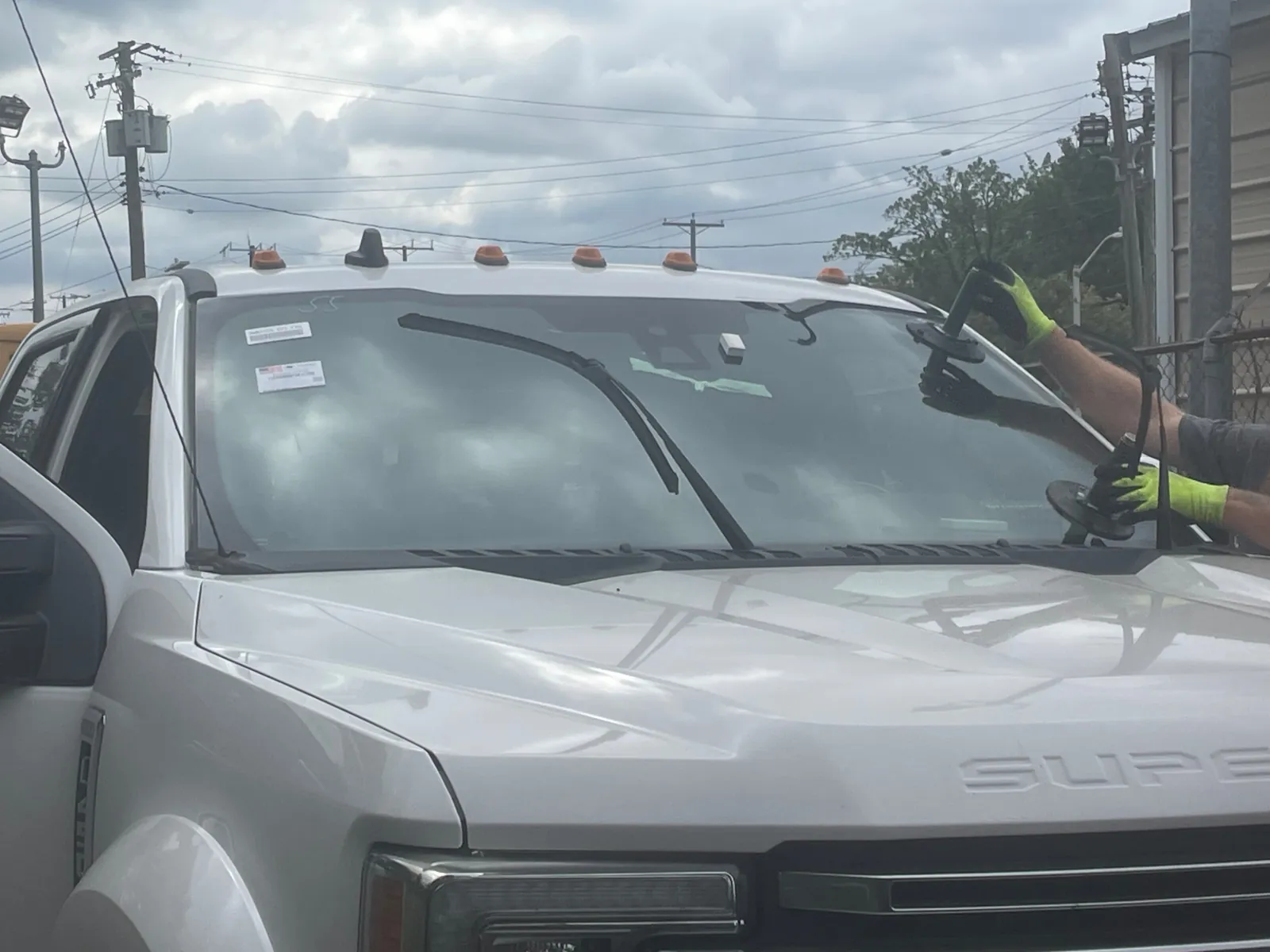 MCA installer using suction cups to place a truck windshield